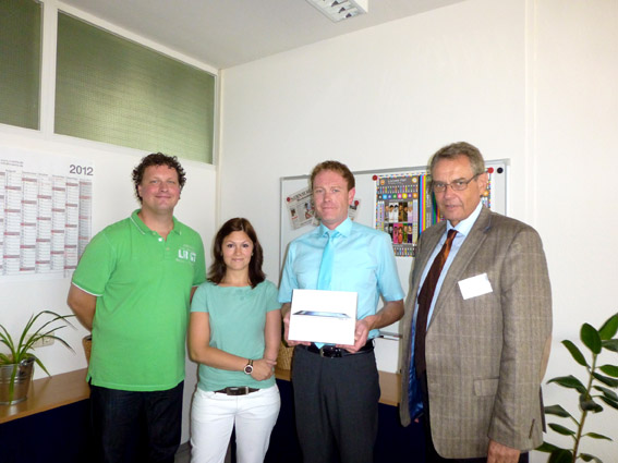 Joerg Zaegelein, Quality Management Verlag Nuernberger Presse (centre) is pleased with his new iPad. Additionally on the picture (from left to right): Jens Untermeier, Deputy Head Rotary Printing, and Kerstin Schwarzmeier, Technical Procurement, both Verlag Nuernberger Presse, and Bernd Blessing, Sales Manager Flint Group Print Media Europe.