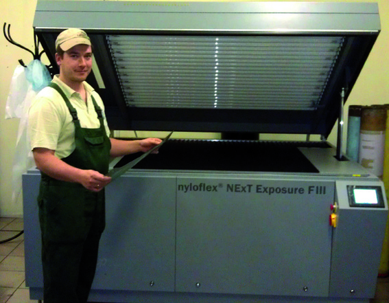 A Conflex staff member prepares the exposure of a printing plate